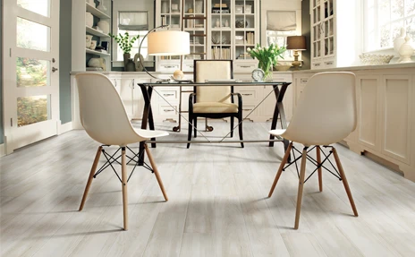 Living room with soft grey and cream furniture and carpet.